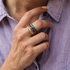 Colorful resin rings styled together to create a custom stacking ring set on model