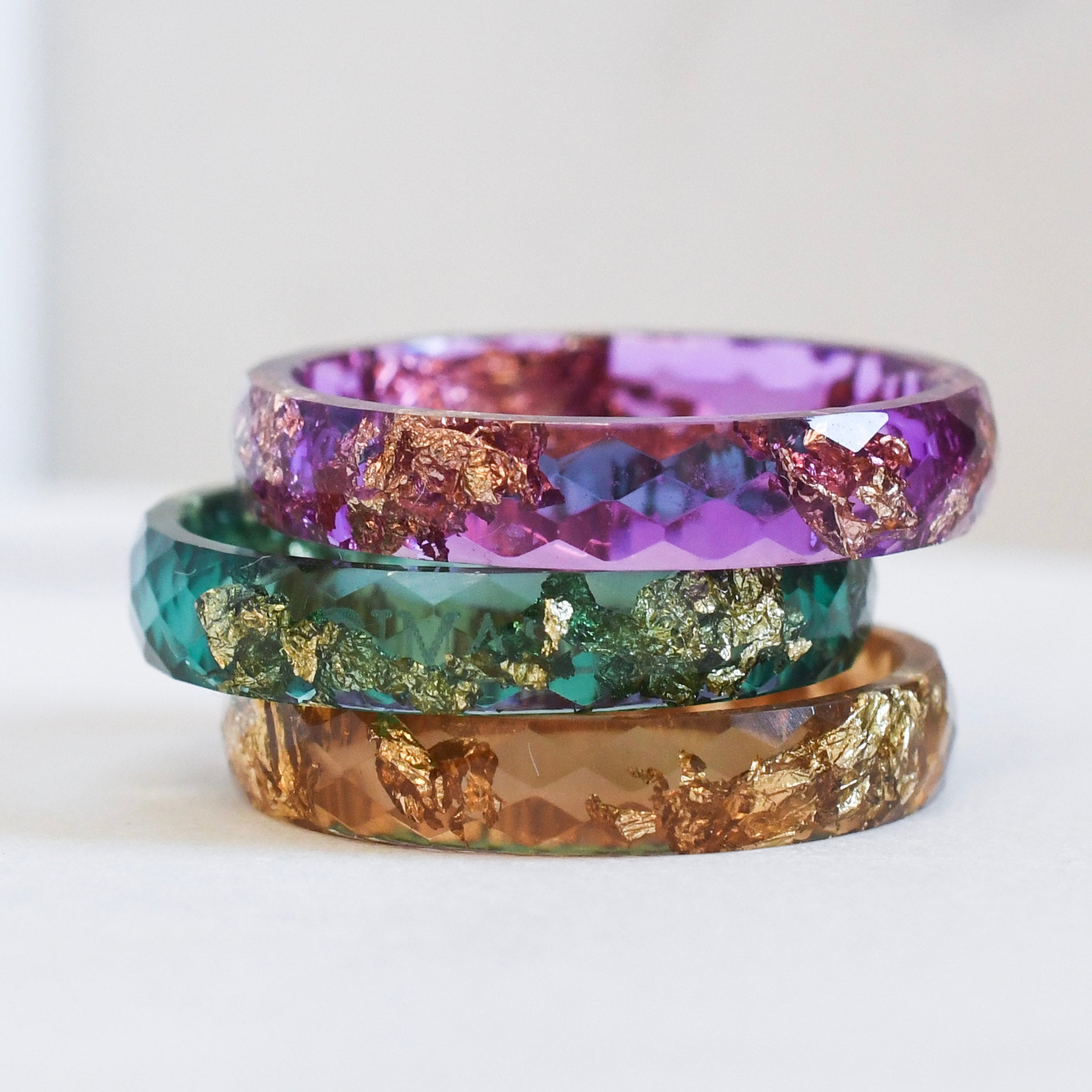 candy stack with purple, green and amber resin rings with gold flakes, handmade in Vienna