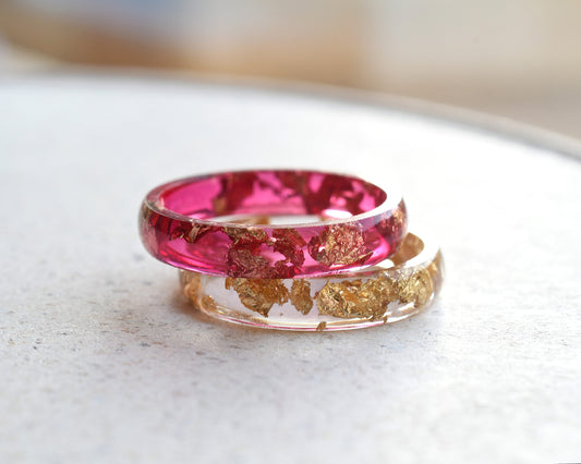 Cherry red resin ring with gold flakes worn on hand