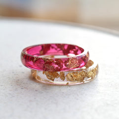 Cherry red resin ring with gold flakes worn on hand