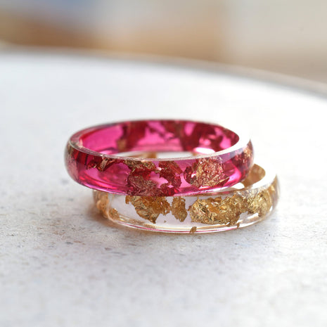 Cherry red resin ring with gold flakes worn on hand