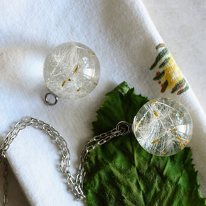 Clear resin jewelry with preserved dandelion