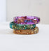 Colorful resin stacking rings set with gold flakes worn together on hand
