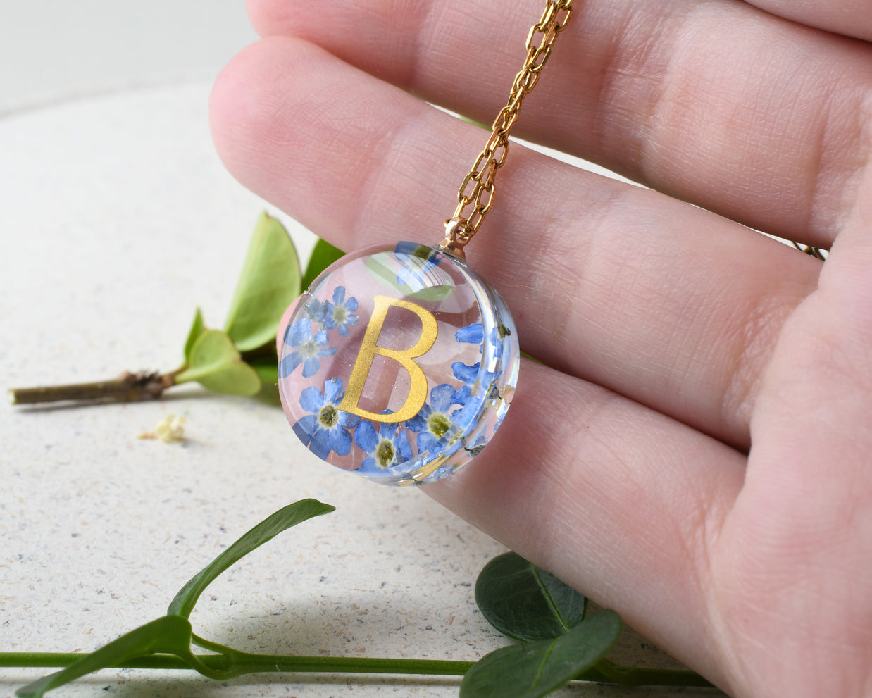 Real flower pendant necklace with forget-me-nots and gold chain