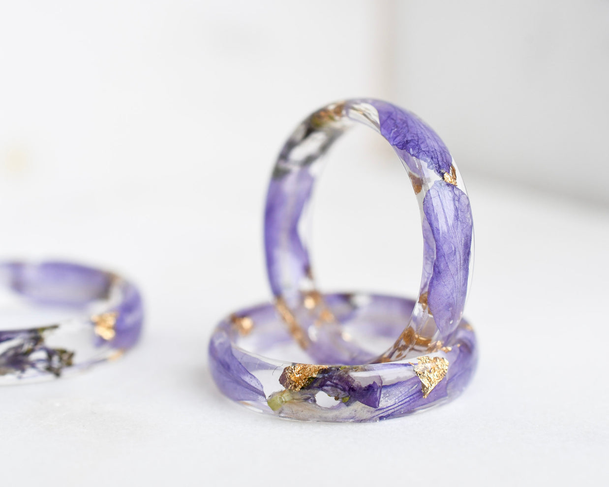 Purple ring with gold accents on a white background