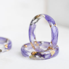 Purple ring with gold accents on a white background