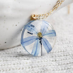 Delicate real-flower resin necklace with blue squill and fine gold chain.