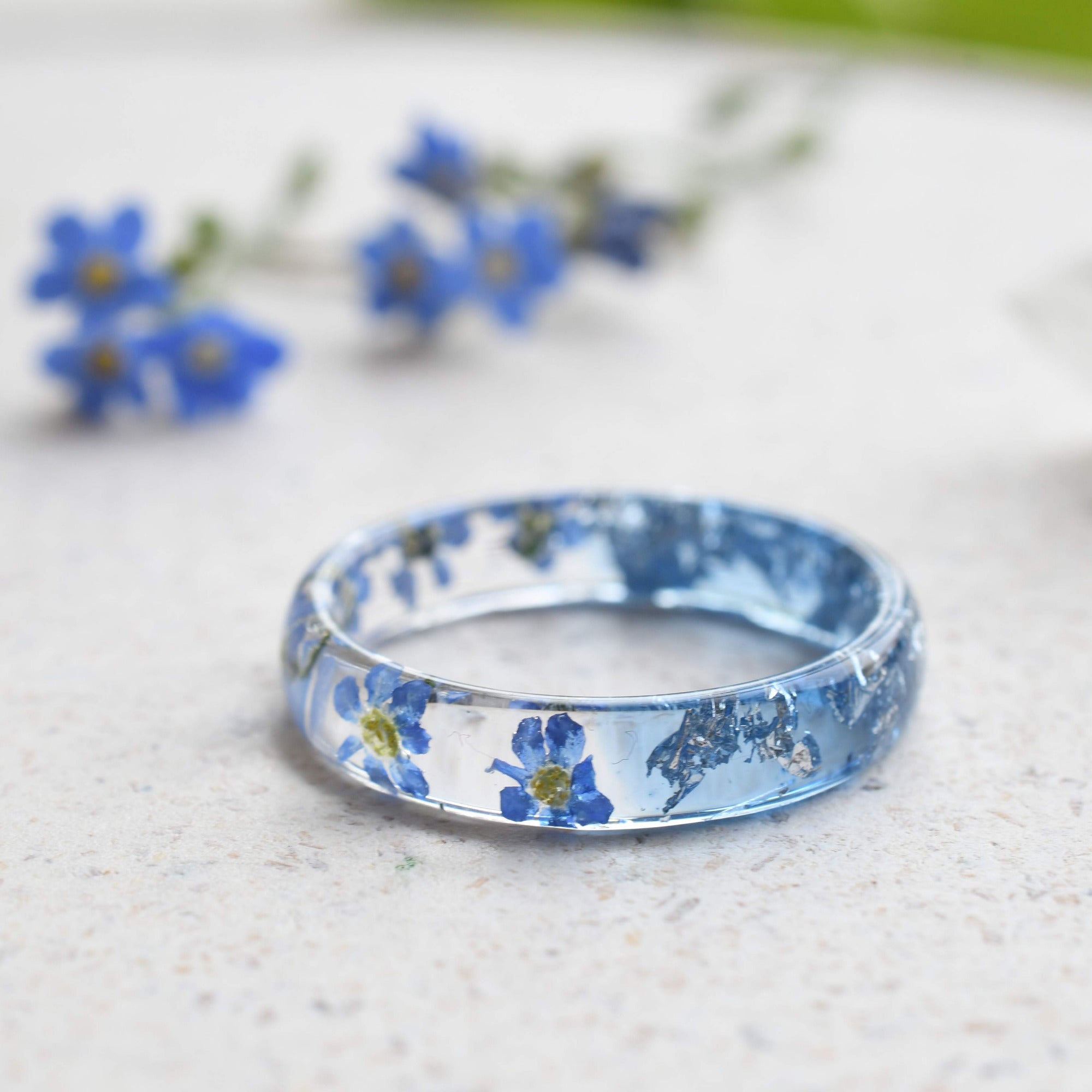Handmade resin flower ring with delicate silver leaf accents