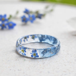 Handmade resin flower ring with delicate silver leaf accents