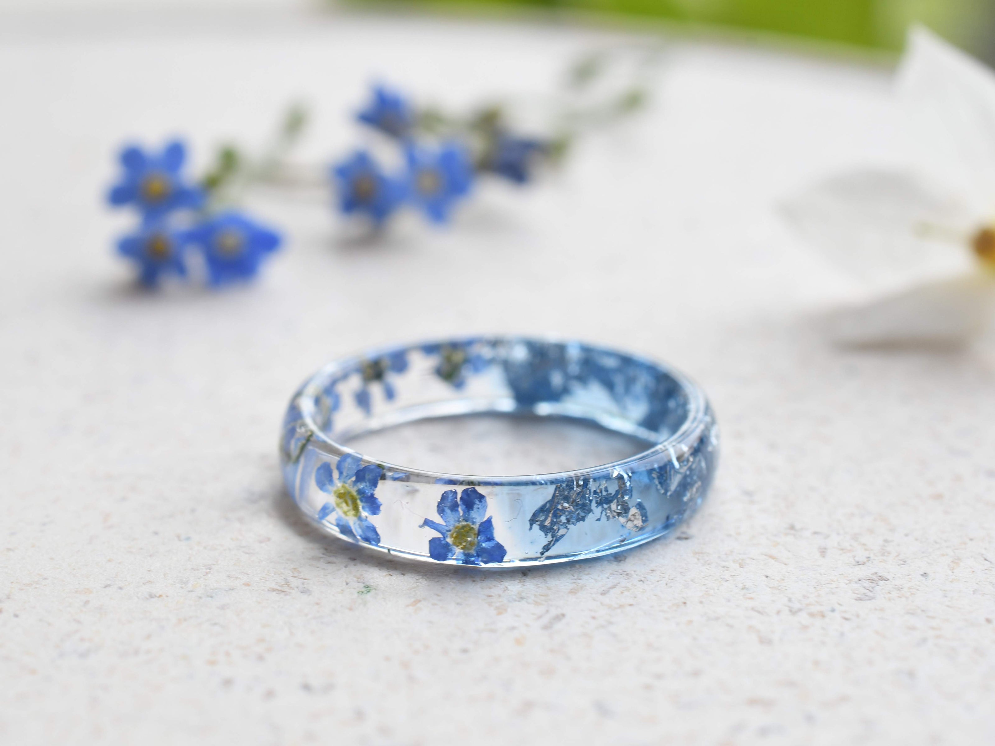 Handmade resin flower ring with delicate silver leaf accents
