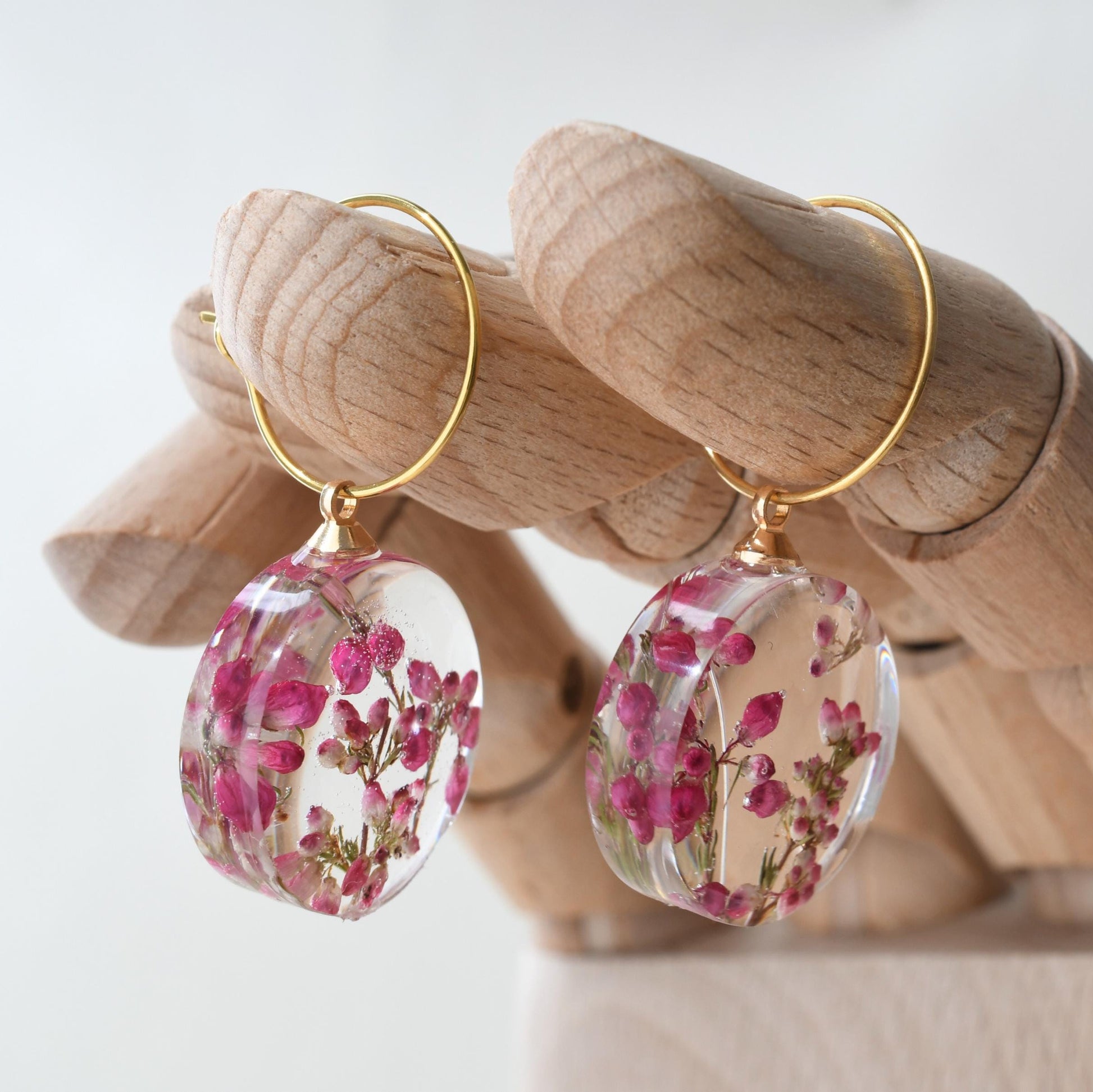 Delicate hoop earrings with real pink heather flowers preserved in resin