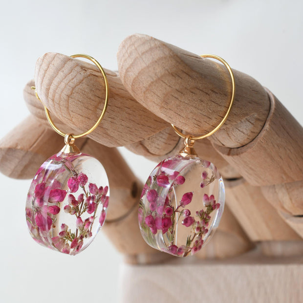 Delicate hoop earrings with real pink heather flowers preserved in resin
