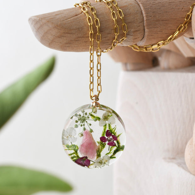 Terrarium necklace with pink tourmaline, moss, and alyssum flowers handmade by Resity in Vienna