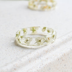 Clear resin ring with delicate white flowers inside