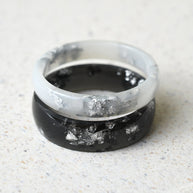Matching black and white resin couple rings with silver leaf handmade by Resity in Vienna
