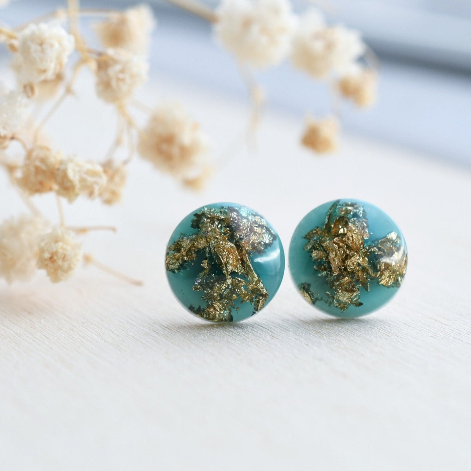 Emerald green resin stud earrings with gold flakes handmade by Resity in Vienna