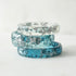 Slim faceted aqua resin stacking ring with metallic silver flakes handmade in Vienna