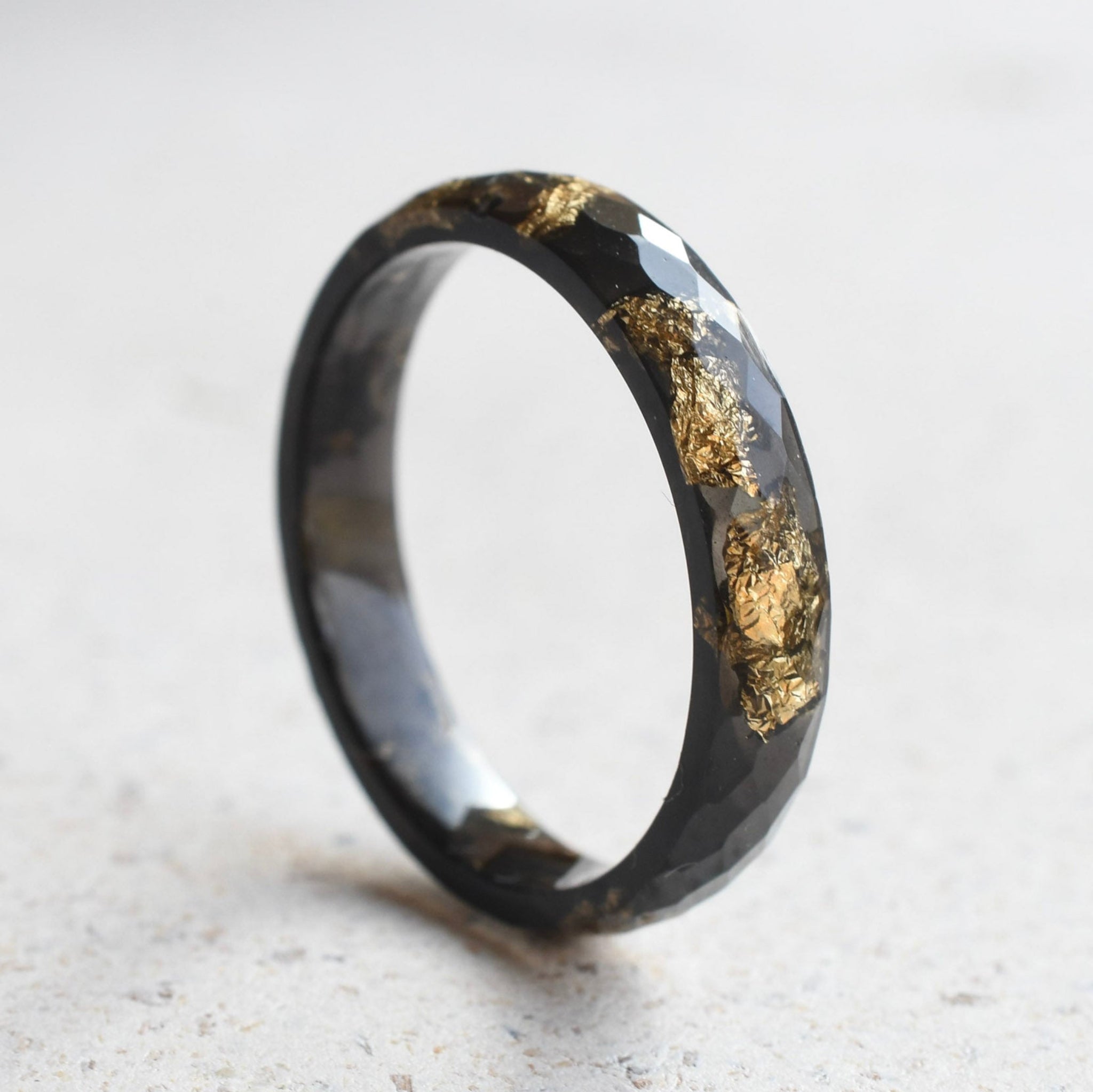 Slim faceted black resin stacking ring with metallic gold leaf handmade in Vienna
