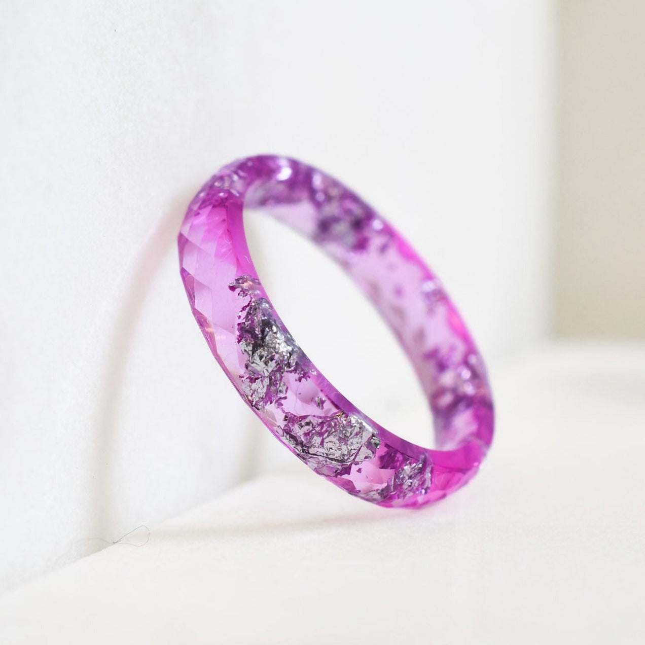 Faceted pink resin ring with metallic silver flakes