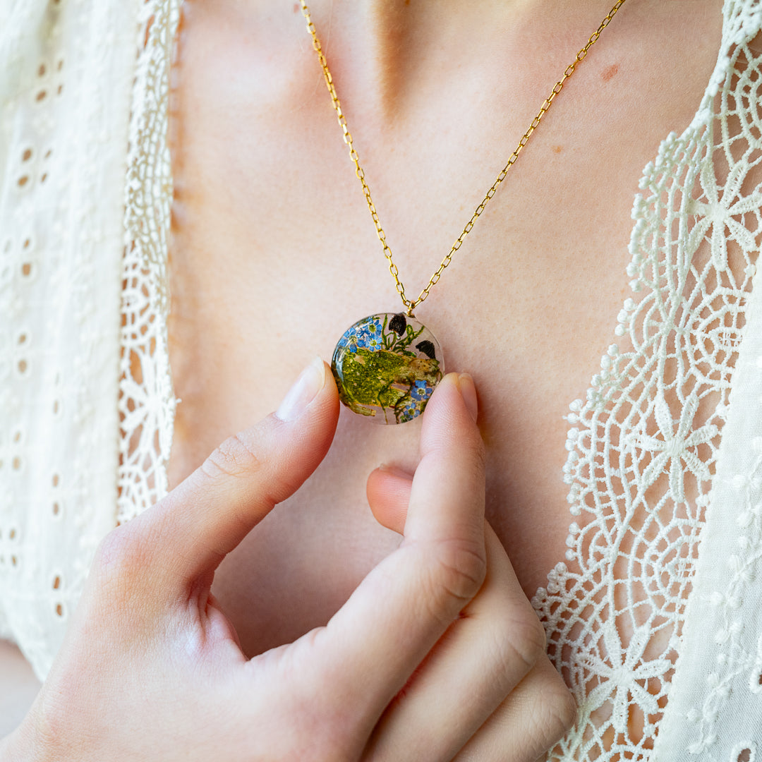 Necklace with real forget-me-not flowers, mushrooms, and tree bark handmade by Resity in Vienna