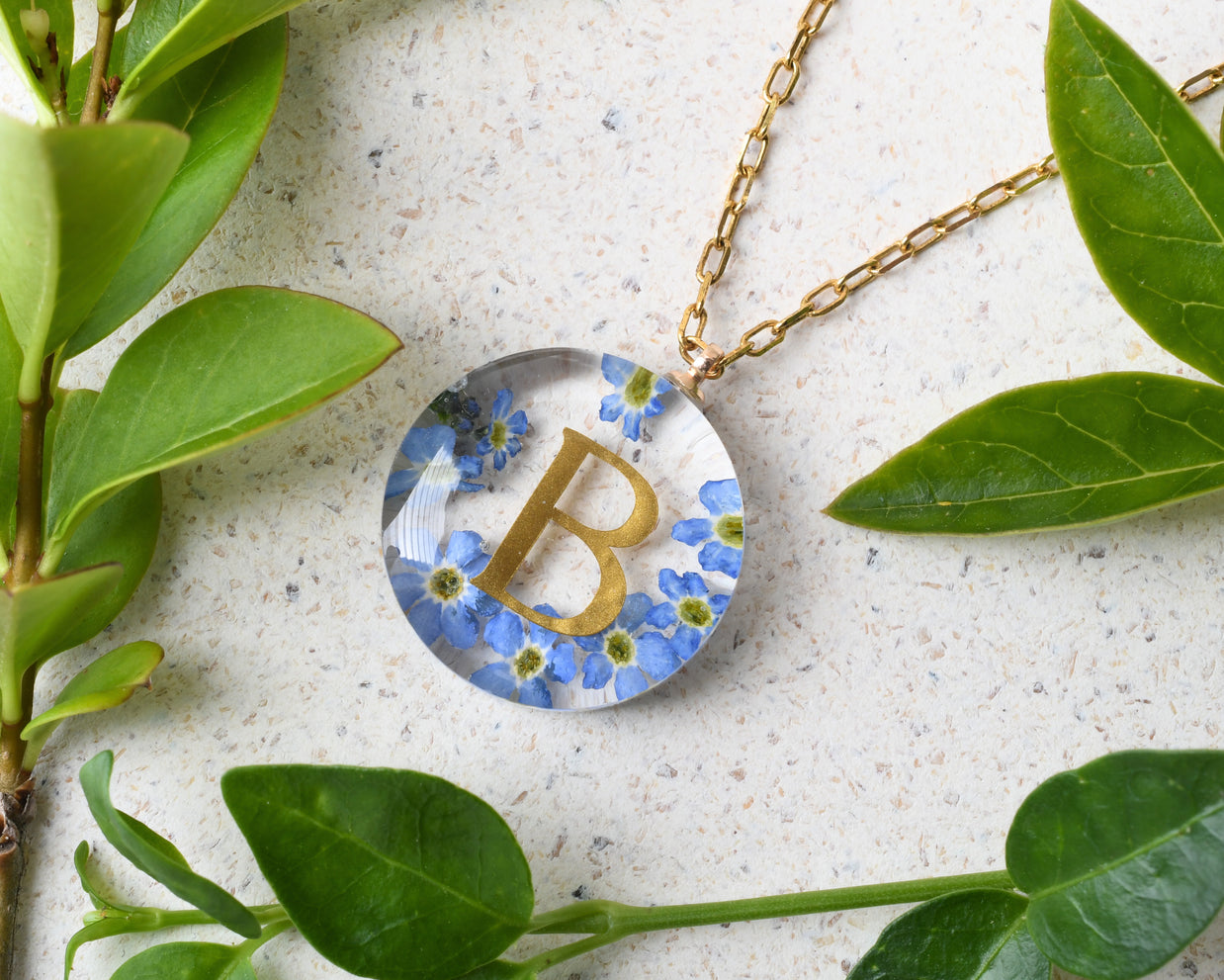 Unique custom necklace gift with resin, flowers, and golden writing