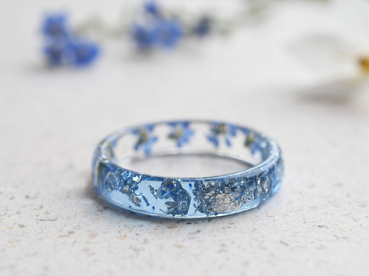 Forget-me-not resin ring with aqua band and shimmering silver details