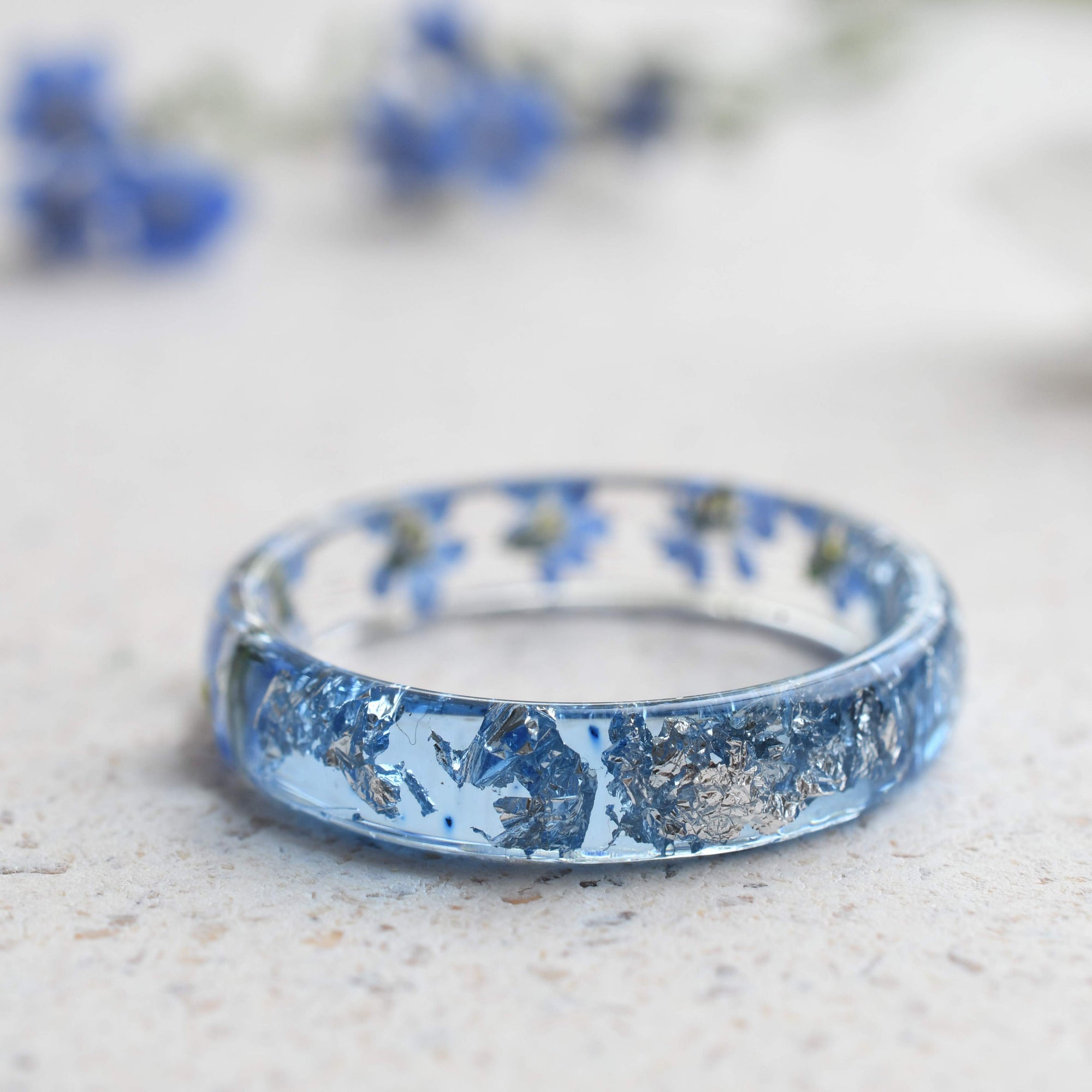 Forget-me-not resin ring with aqua band and shimmering silver details