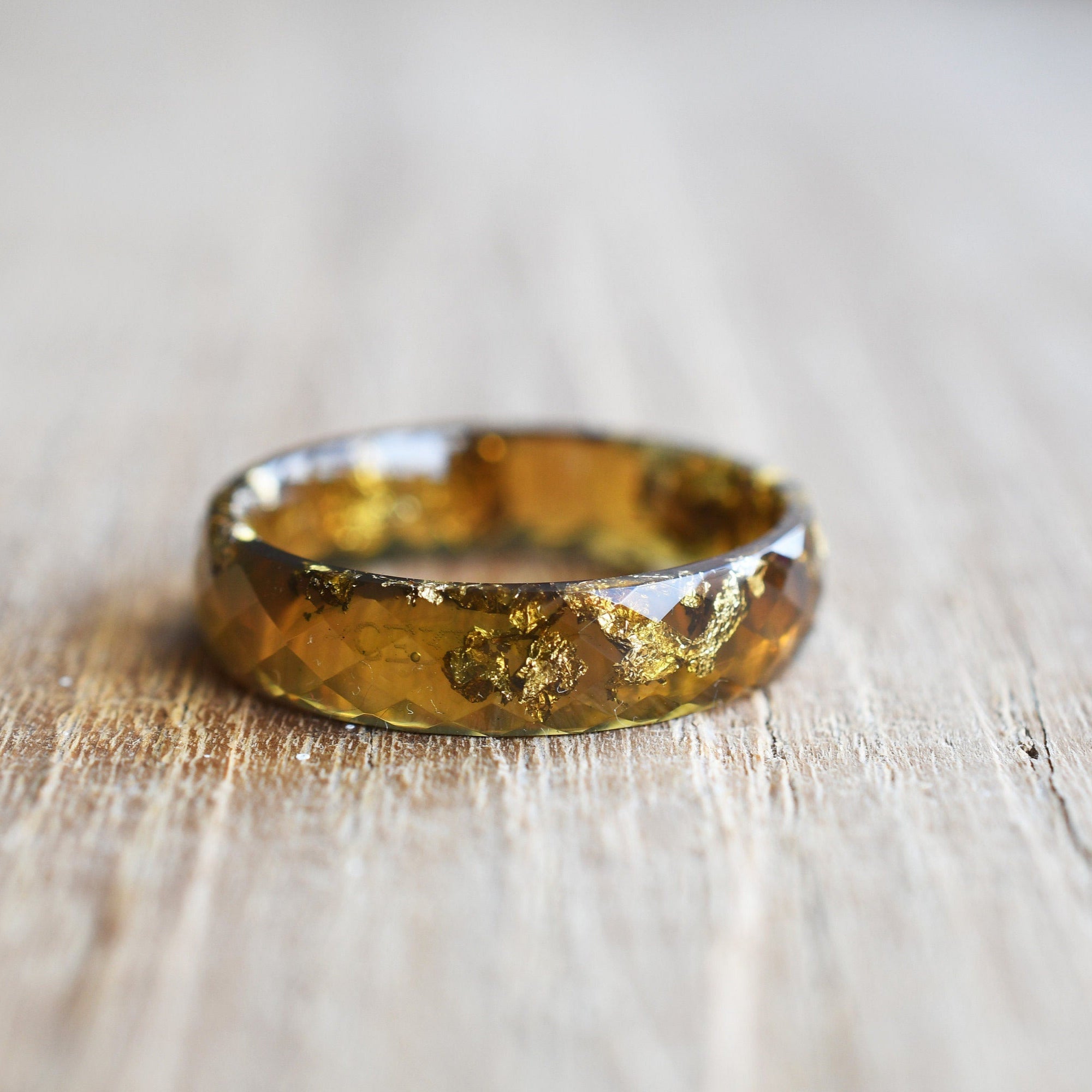 lose-up of gold flakes inside amber resin ring handmade by Resity