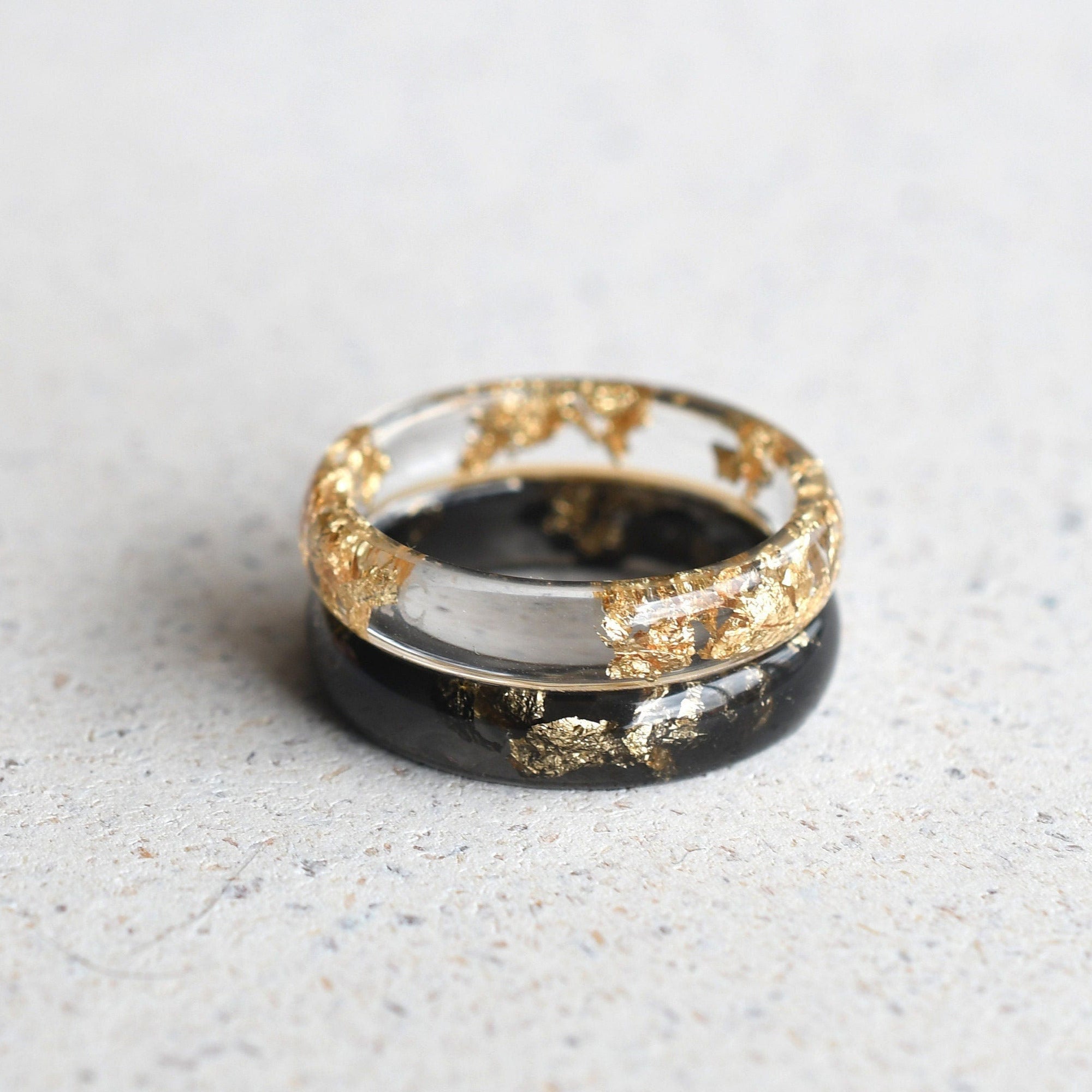 Smooth black and clear resin couples rings with gold flakes handmade by Resity in Vienna