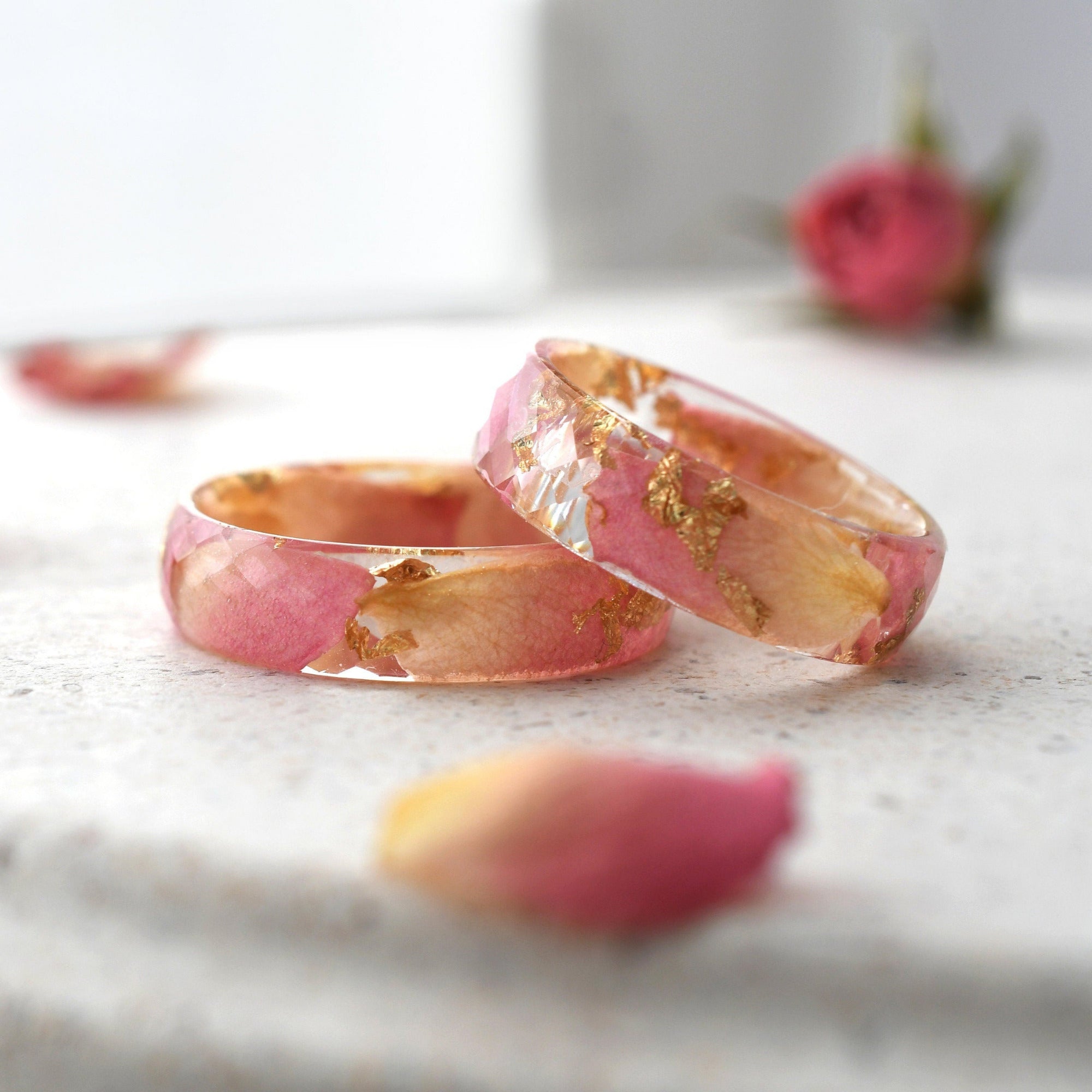 a close up of two wedding rings on a table