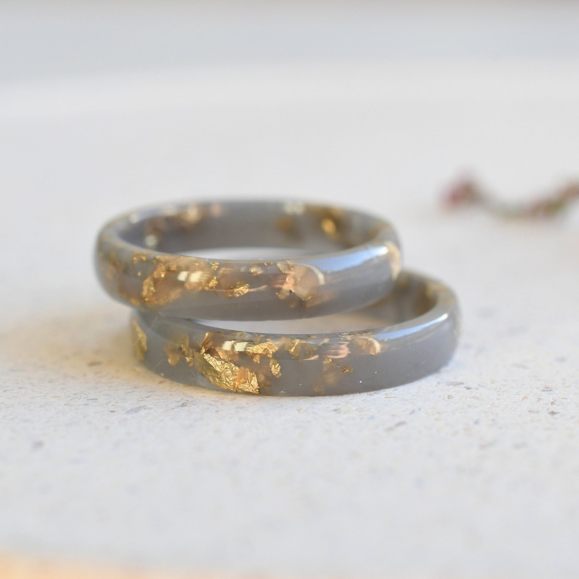 Thin matte gray resin ring with shimmering gold leaf — minimalist jewelry