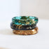 Faceted green resin ring with gold flakes close-up