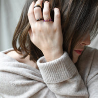 Stackable thin purple resin ring with gold flakes worn by model