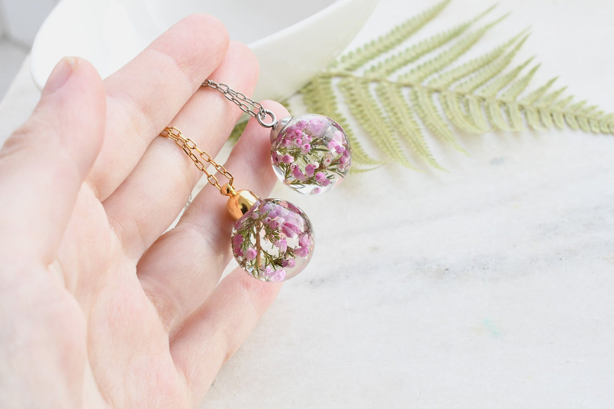Heather Moon Necklace hanging from silver chain, emphasizing sphere shape and detail