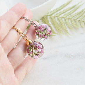 Heather Moon Necklace hanging from silver chain, emphasizing sphere shape and detail