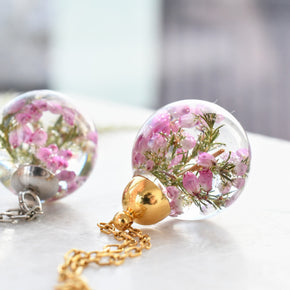 Side view of resin sphere pendant showing clarity and gentle floral detail