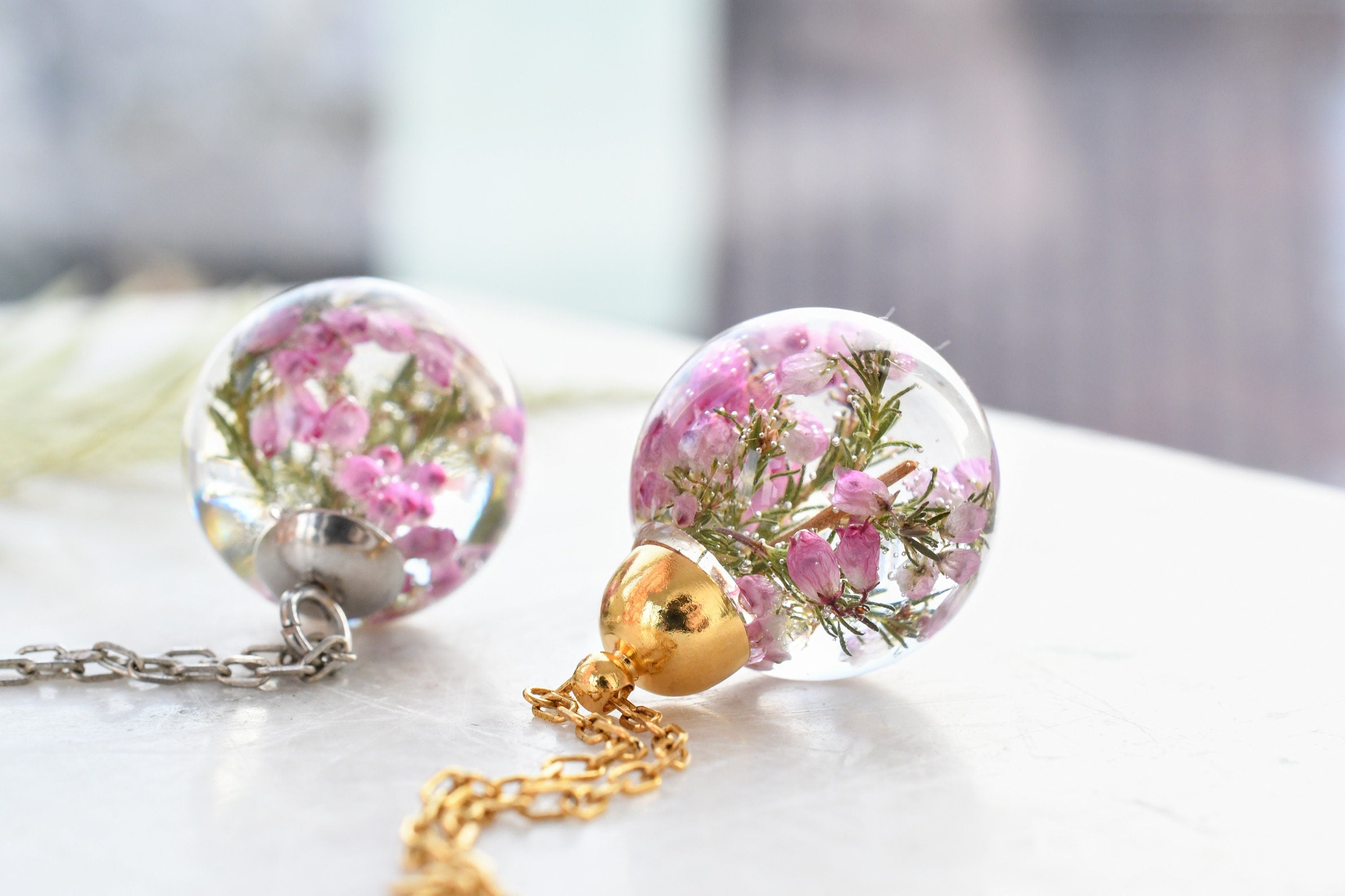 Side view of resin sphere pendant showing clarity and gentle floral detail