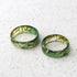 a couple of green rings sitting on top of a white floor