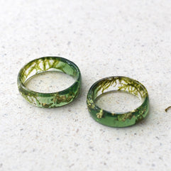 a couple of green rings sitting on top of a white floor