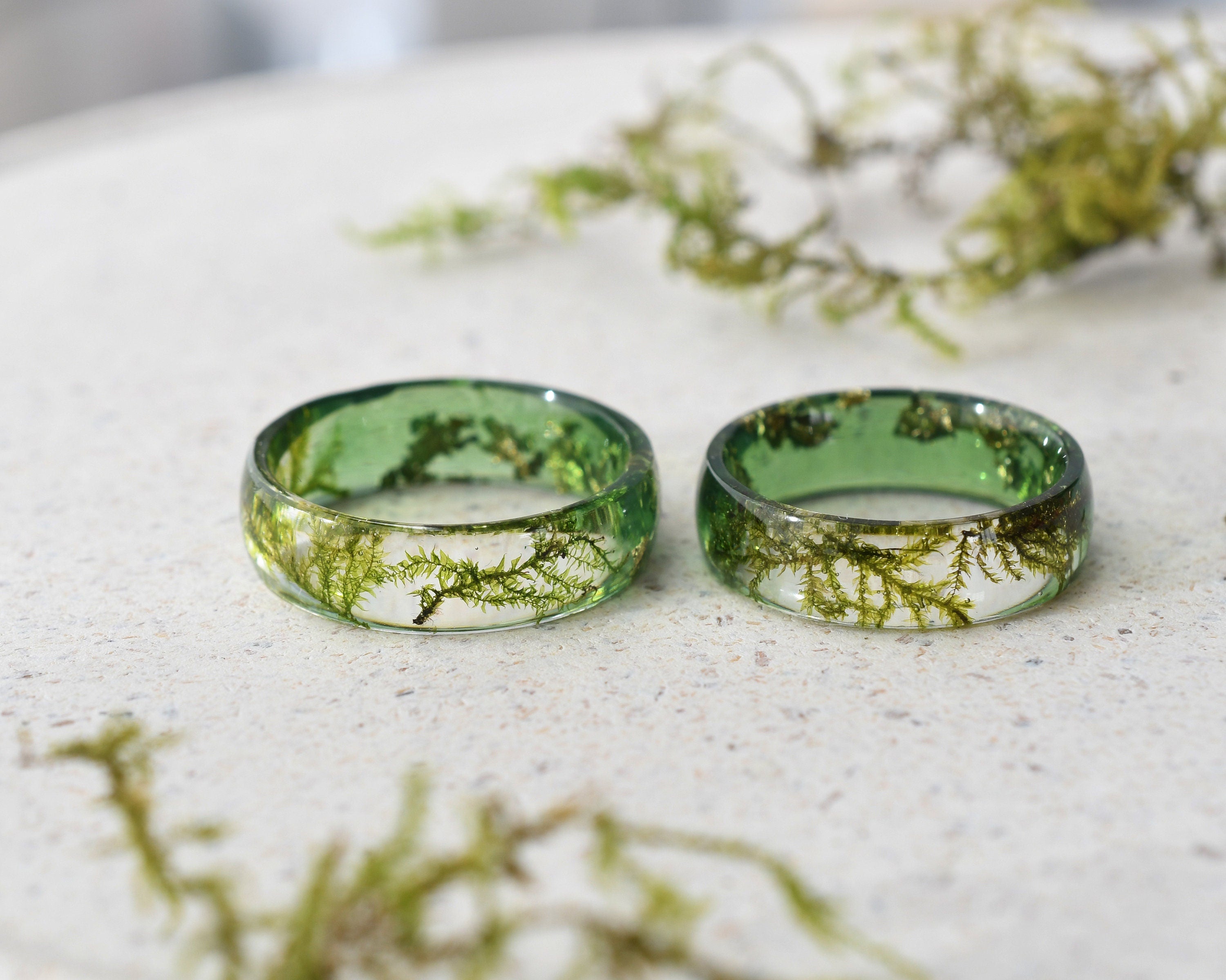two green rings sitting on top of a white table
