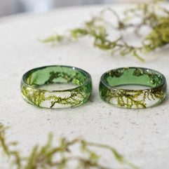 two green rings sitting on top of a white table