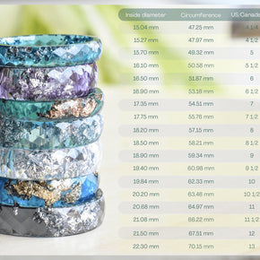 Stack of colorful rings with a size chart on a white background