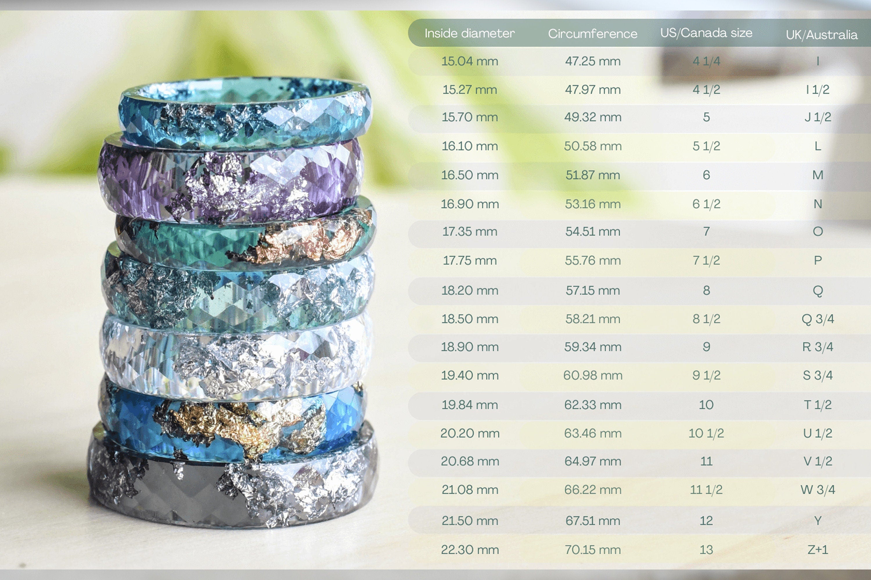 Stack of colorful rings with a size chart on a white background