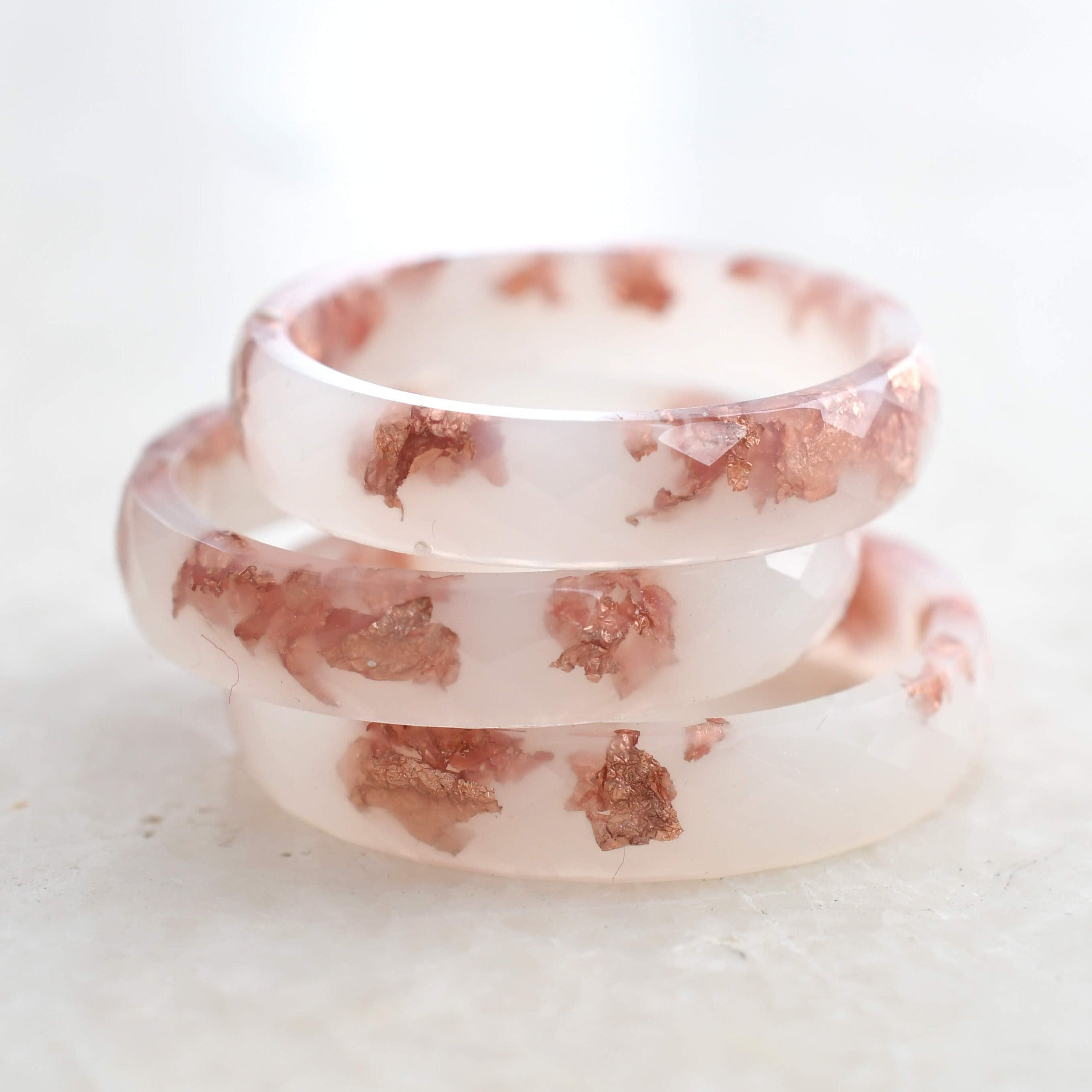 Minimalist off-white resin ring with delicate rose gold flakes — modern wedding band