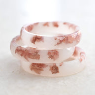 Minimalist off-white resin ring with delicate rose gold flakes — modern wedding band