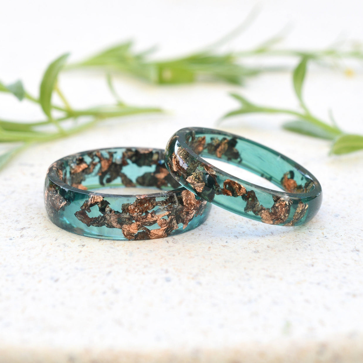 Close-up of jade resin rings with rose gold leaf flakes handmade in Vienna