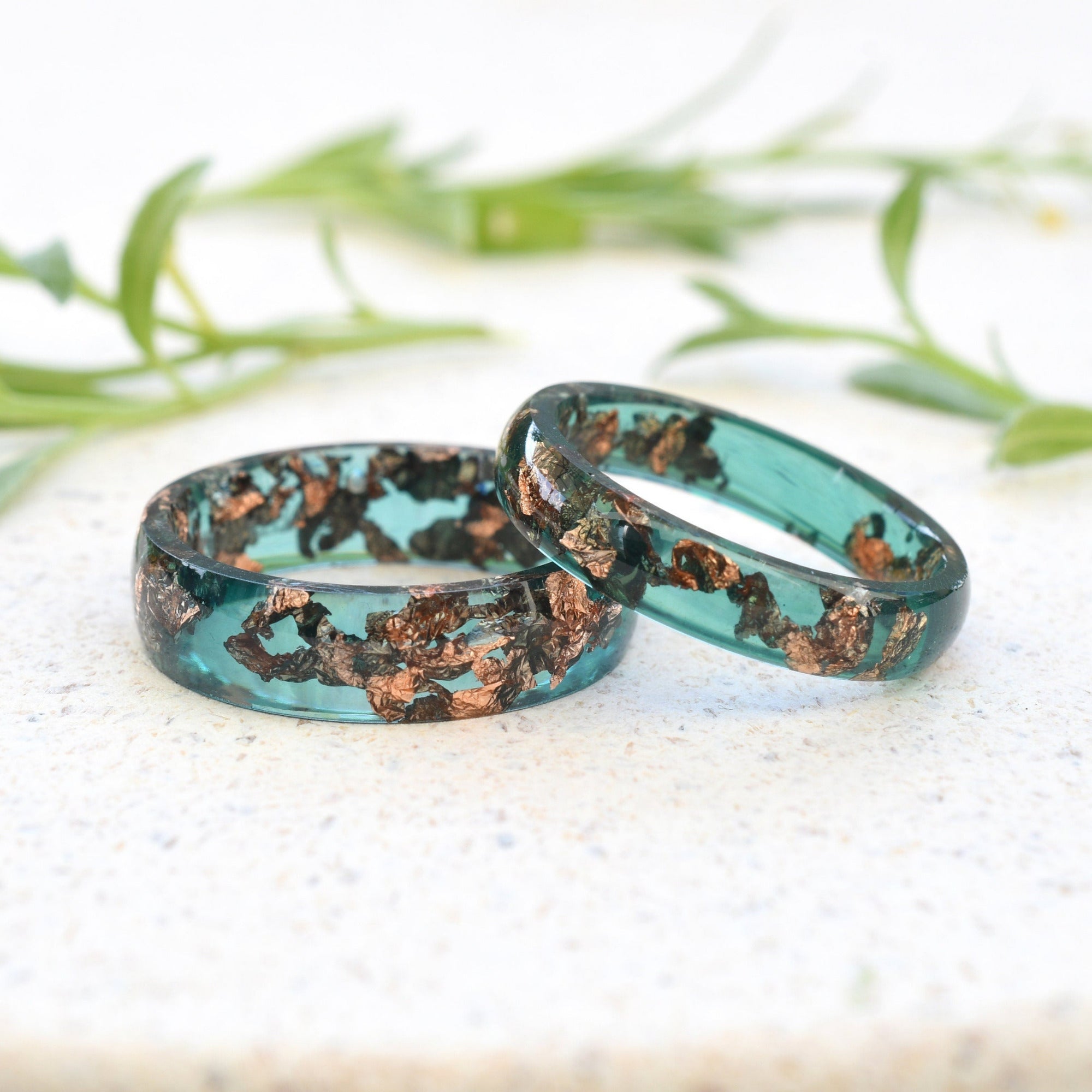 Close-up of jade resin rings with rose gold leaf flakes handmade in Vienna