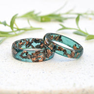 Close-up of jade resin rings with rose gold leaf flakes handmade in Vienna