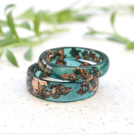 Matching jade green resin couple rings with rose gold leaf handmade by Resity in Vienna