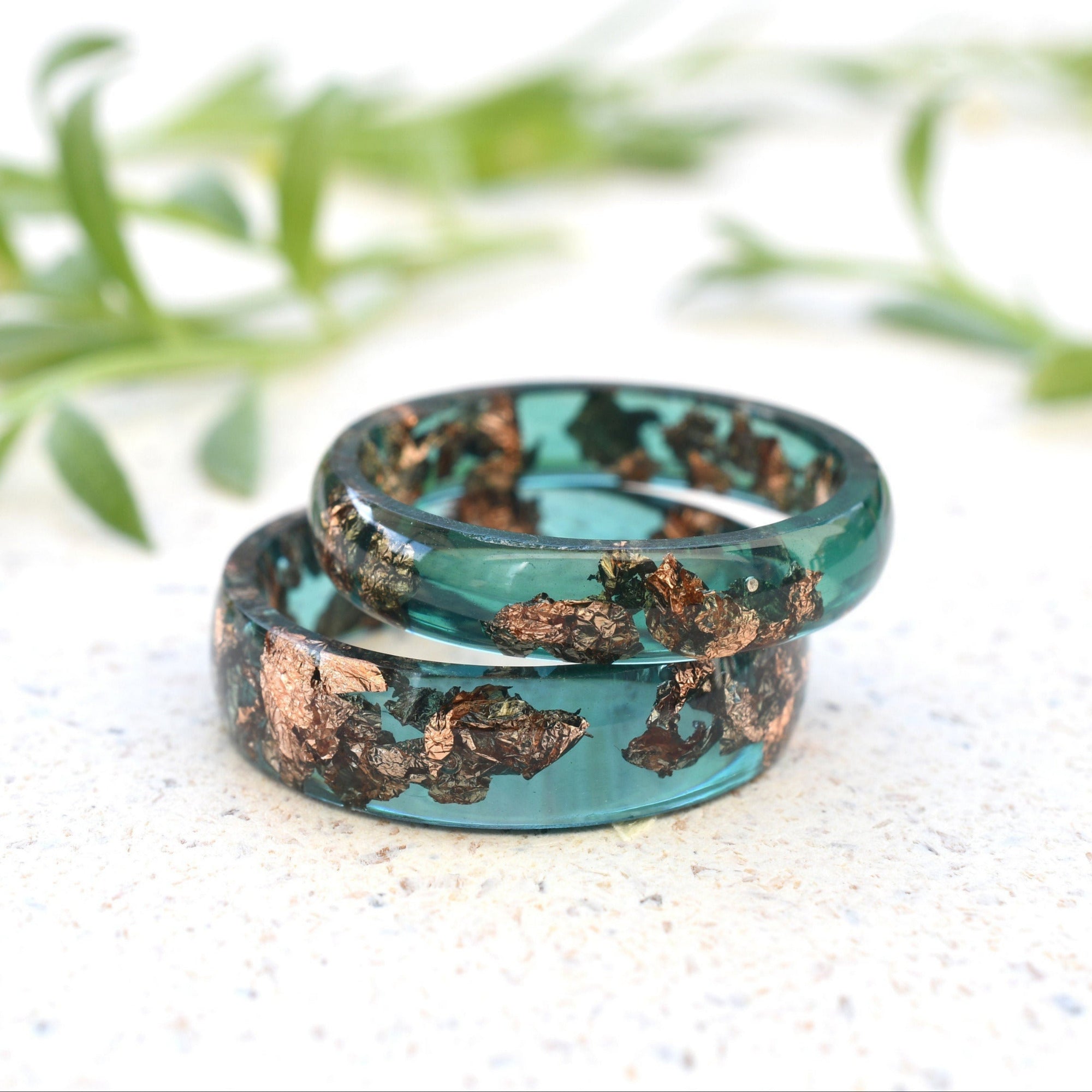 Matching jade green resin couple rings with rose gold leaf handmade by Resity in Vienna